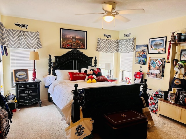 bedroom featuring ceiling fan and carpet