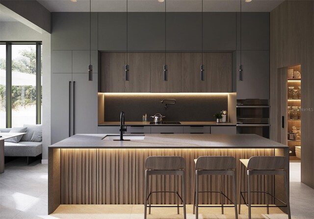 bar with sink and black double oven