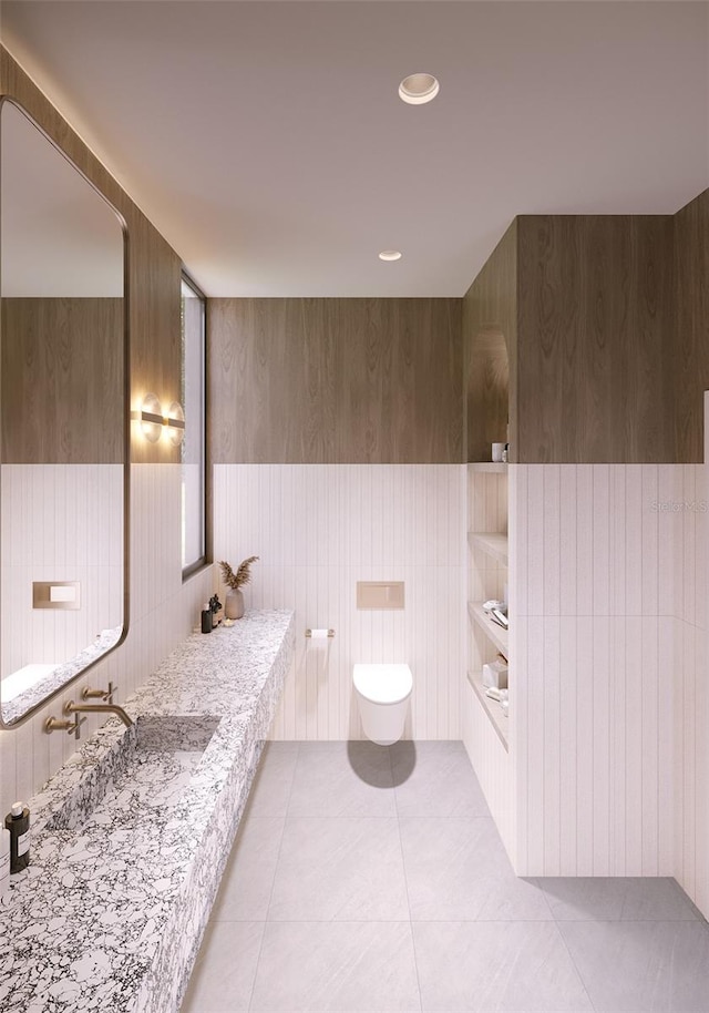 bathroom with vanity, tile patterned floors, toilet, and wood walls