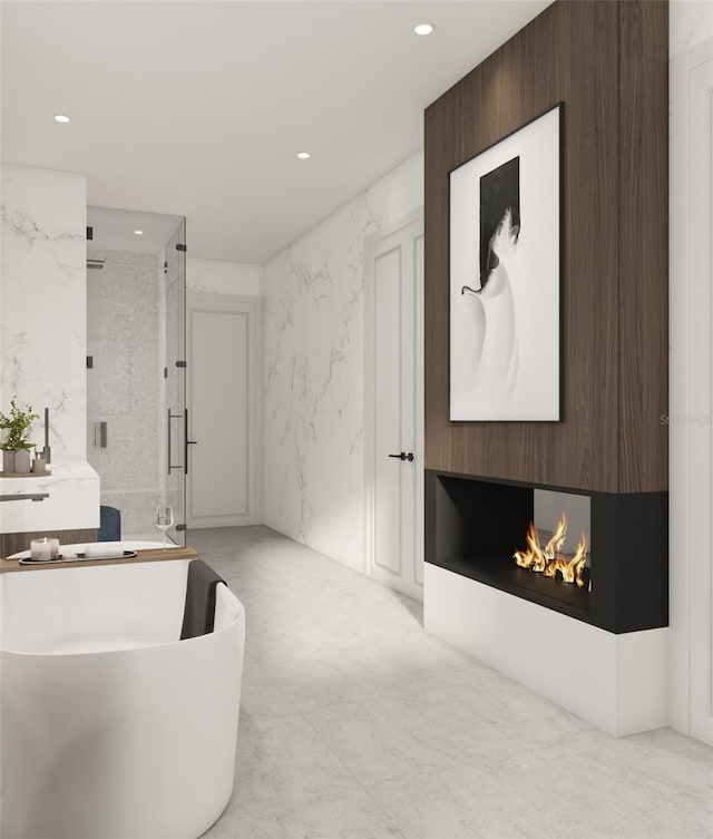 bathroom with vanity, independent shower and bath, and a large fireplace