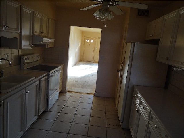 kitchen featuring white appliances, sink, ceiling fan, tasteful backsplash, and light tile patterned flooring