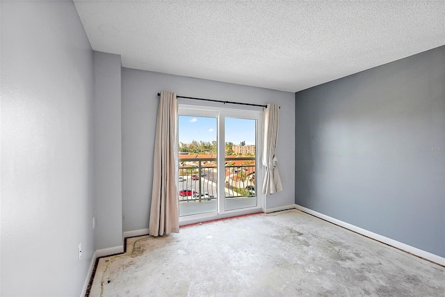 empty room with concrete floors and a textured ceiling