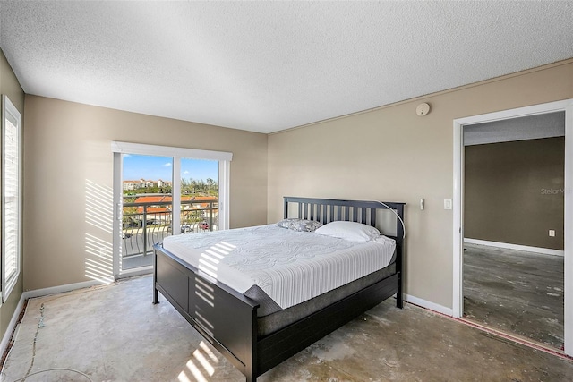 bedroom featuring access to outside, a textured ceiling, and concrete flooring