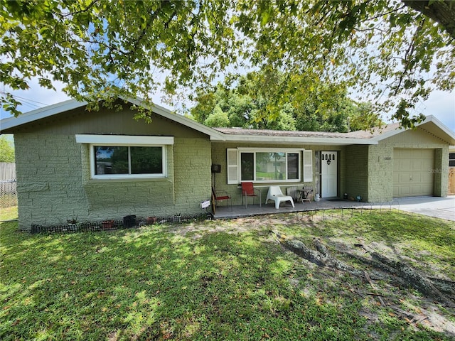 single story home featuring a front lawn and a garage