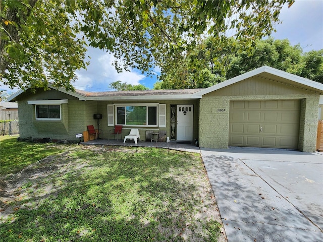 single story home featuring a front yard and a garage