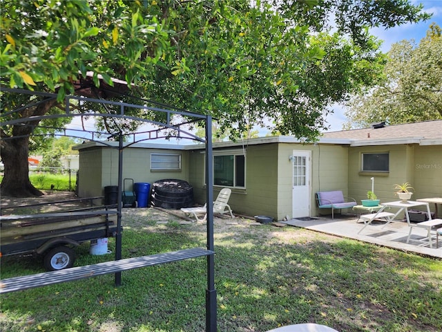 exterior space with a patio area and a lawn