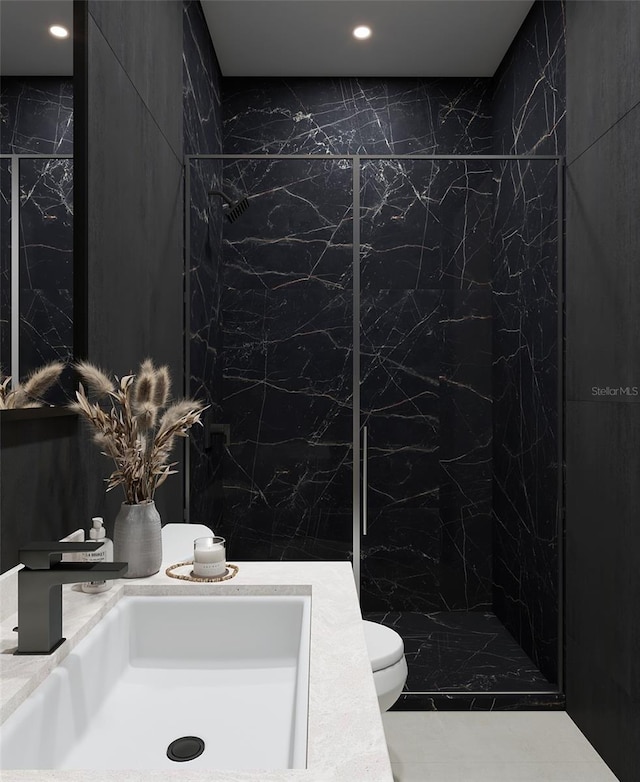 bathroom with tile walls, vanity, a shower, and toilet