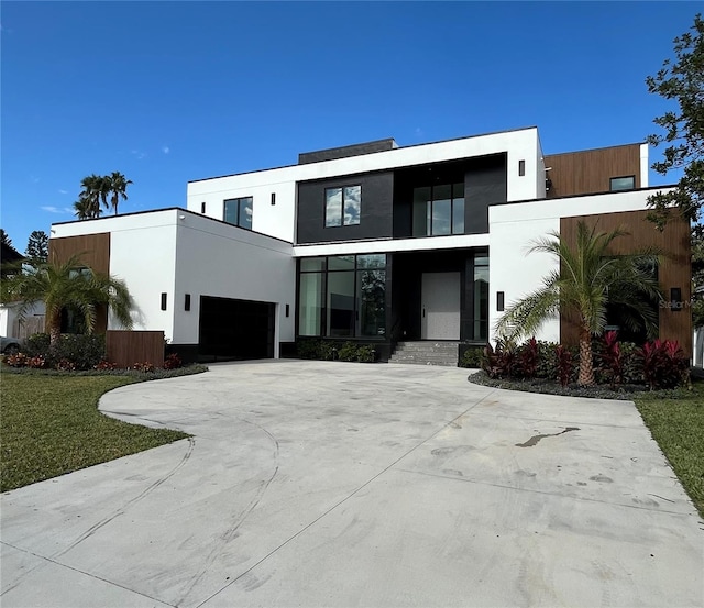 contemporary house with a front yard and a garage