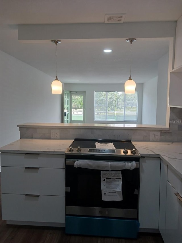 kitchen featuring light stone countertops, decorative light fixtures, stainless steel range with electric cooktop, and dark hardwood / wood-style floors