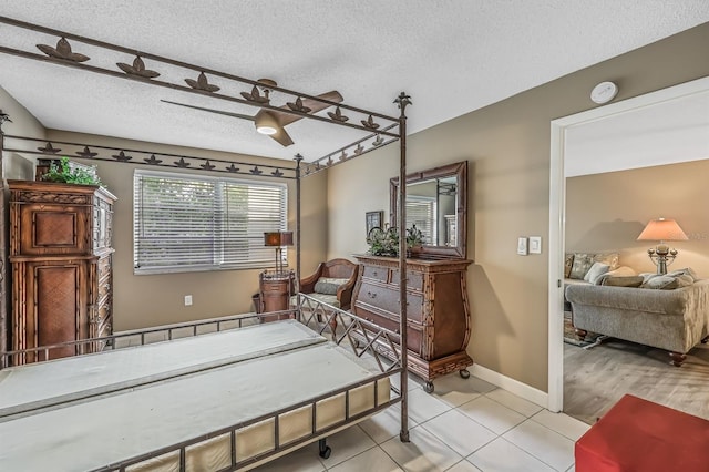 interior space with a textured ceiling and light tile patterned floors