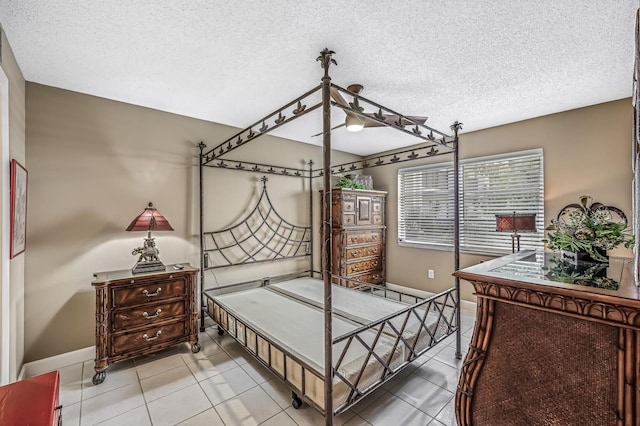 bedroom with a textured ceiling and tile patterned flooring