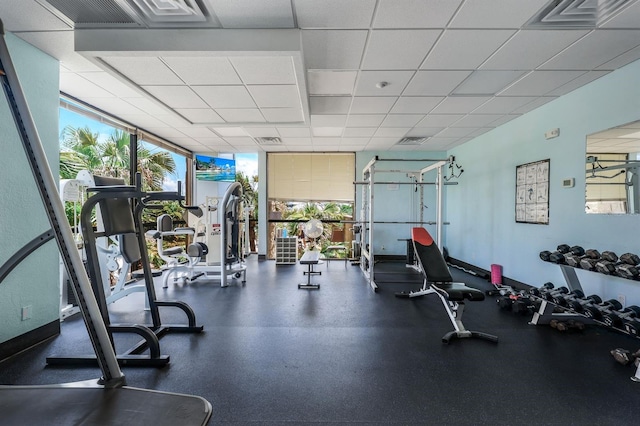 gym with a paneled ceiling