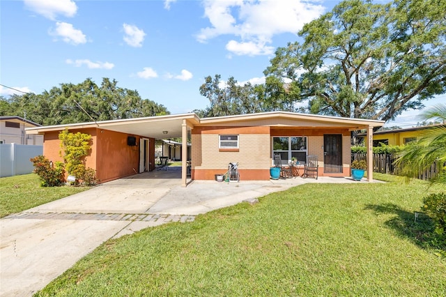 back of property featuring a yard and a carport