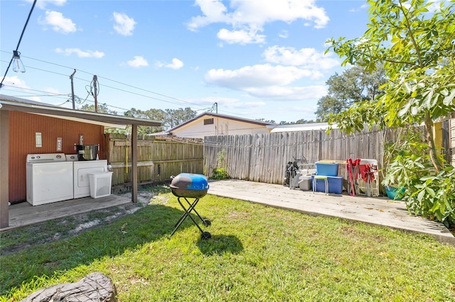 view of yard with washer and dryer and a patio area