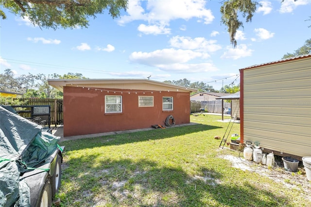 view of side of property with a yard