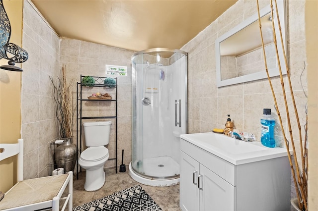 bathroom with vanity, toilet, tile walls, and an enclosed shower