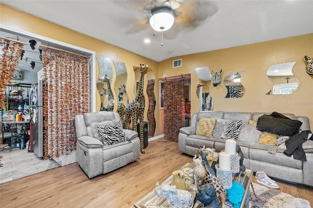 living room with hardwood / wood-style flooring and ceiling fan