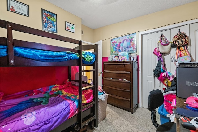 bedroom with a textured ceiling and a closet