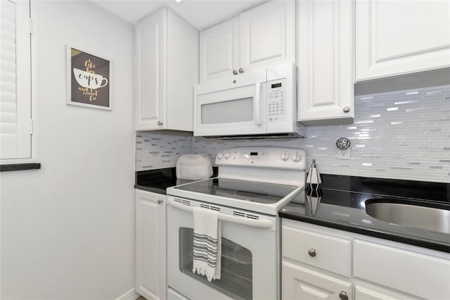 kitchen featuring white cabinets, white appliances, and backsplash