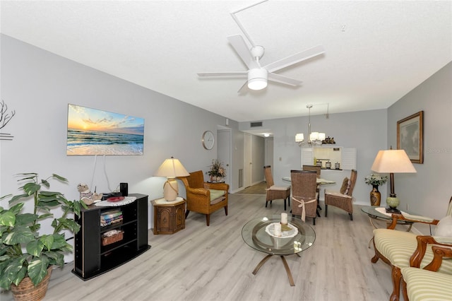 living room featuring ceiling fan and light hardwood / wood-style flooring