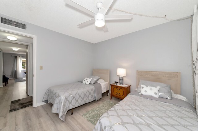 bedroom with ceiling fan and light hardwood / wood-style floors