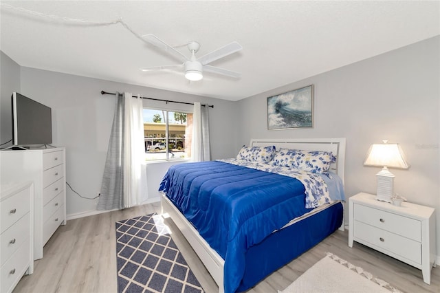 bedroom with ceiling fan and light hardwood / wood-style floors