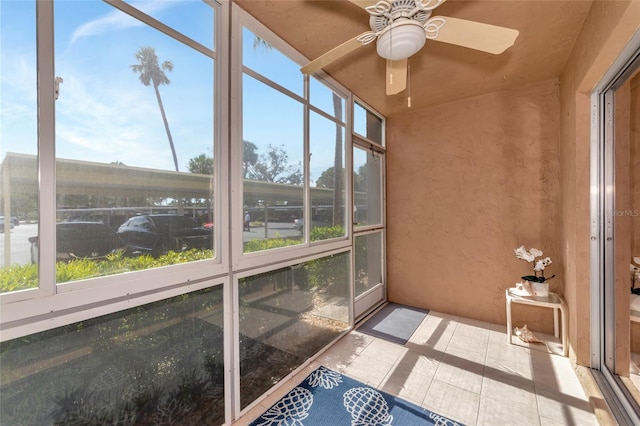 unfurnished sunroom featuring plenty of natural light and ceiling fan