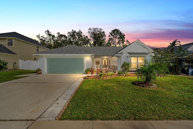 view of front of house featuring a yard and a garage