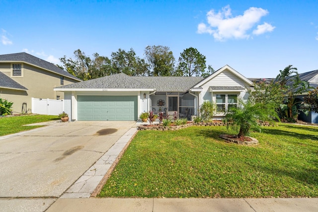 view of front of house featuring a front lawn and a garage