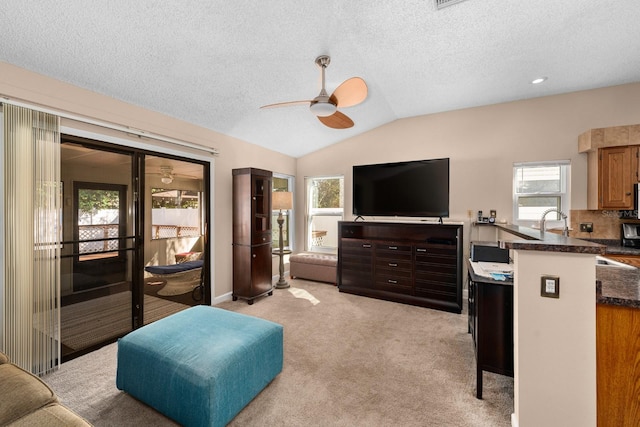 bedroom with ceiling fan, light colored carpet, multiple windows, and lofted ceiling