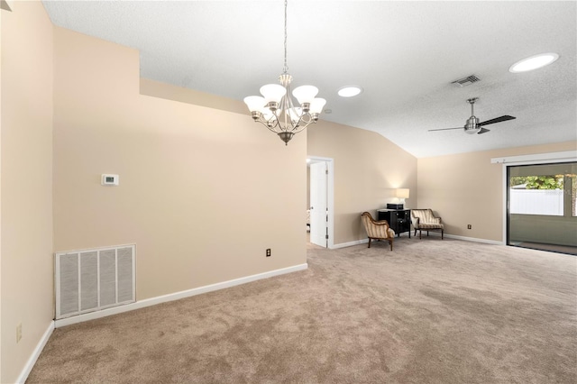 interior space featuring lofted ceiling, ceiling fan with notable chandelier, a textured ceiling, and carpet floors