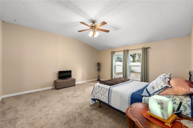 bedroom with vaulted ceiling, light colored carpet, ceiling fan, and a textured ceiling