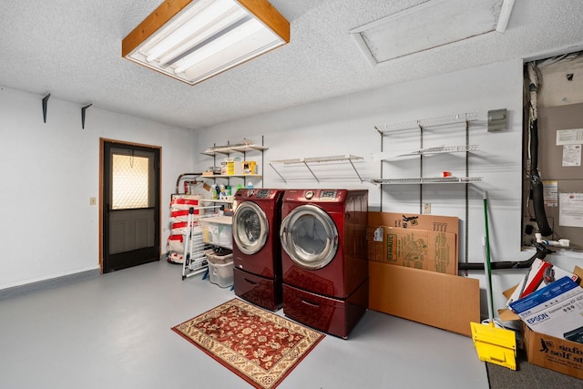 laundry area with washer and dryer and a textured ceiling