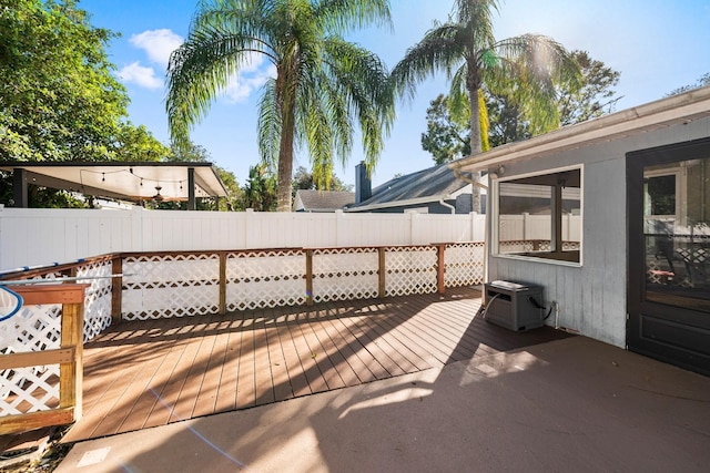 wooden terrace featuring ac unit