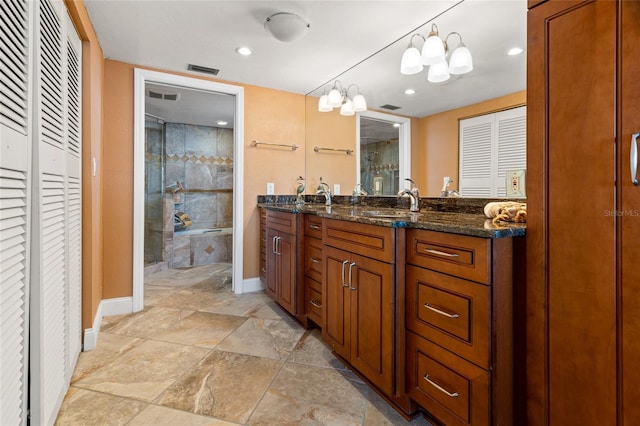 bathroom featuring vanity, an inviting chandelier, and walk in shower