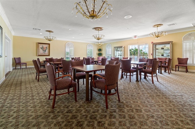 dining room with ornamental molding, a textured ceiling, and an inviting chandelier