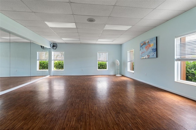 spare room featuring hardwood / wood-style flooring and a paneled ceiling