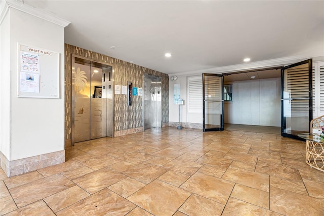 5200 Brittany Dr S Unit 1202, Saint Petersburg, FL 33715 - spare room featuring elevator, crown molding, wood walls, light stone finish flooring, and recessed lighting