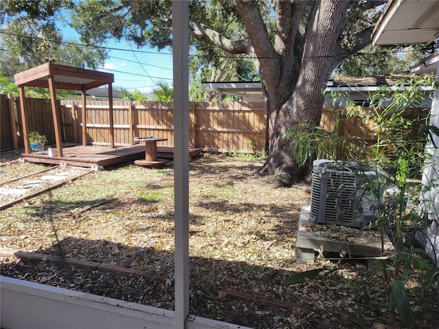 view of yard with a deck and central AC