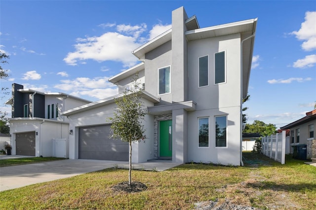 contemporary home featuring a front lawn and a garage