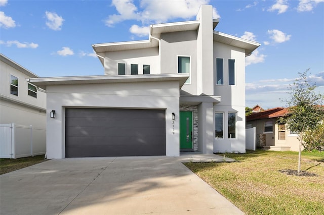 contemporary house with a front yard and a garage