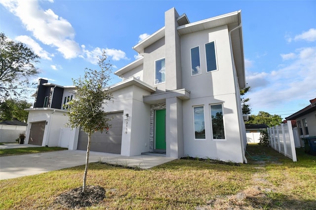 view of front of house featuring a garage and a front lawn