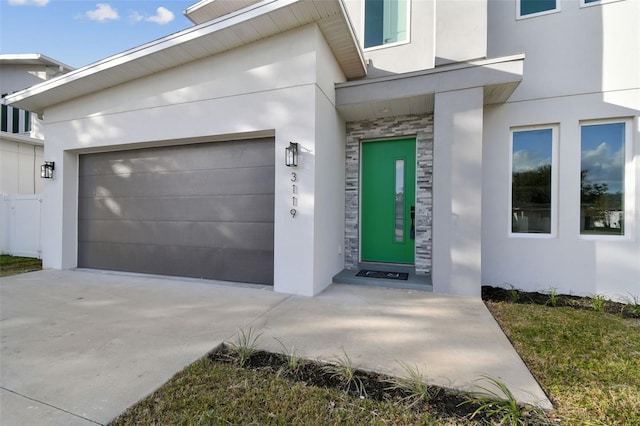 doorway to property with a garage