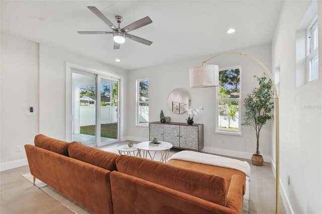 living room featuring ceiling fan and plenty of natural light