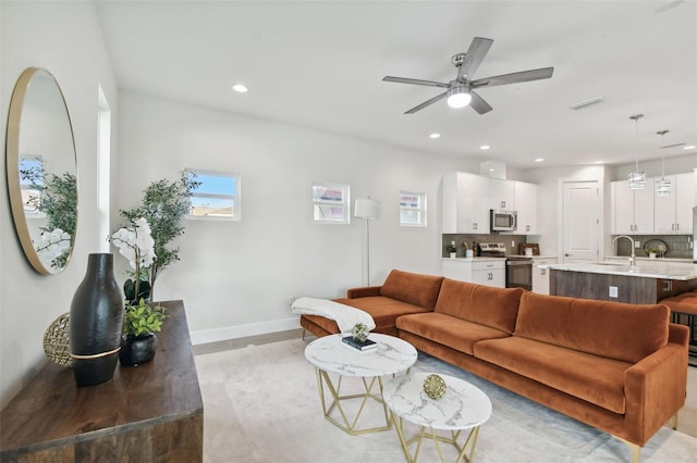 living room featuring sink and ceiling fan