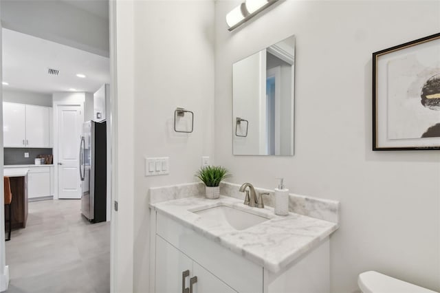 bathroom featuring vanity and toilet