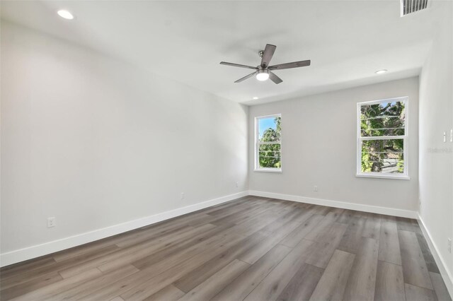 spare room with hardwood / wood-style flooring and ceiling fan