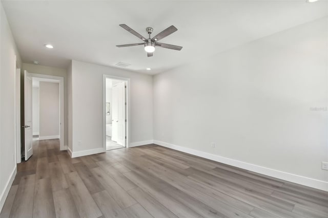 unfurnished bedroom with ensuite bathroom, light hardwood / wood-style floors, and ceiling fan