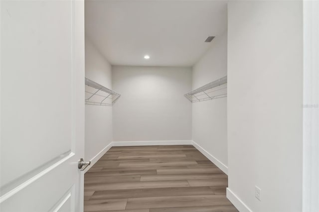 spacious closet featuring hardwood / wood-style floors