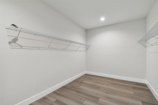 spacious closet featuring light hardwood / wood-style floors